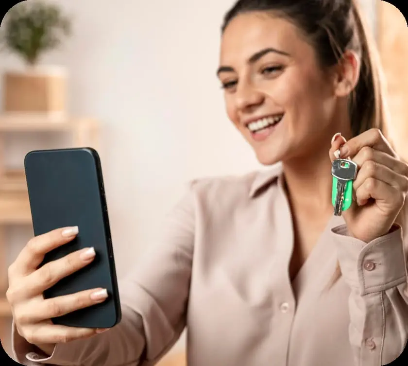 Mujer mostrando un teléfono y llaves